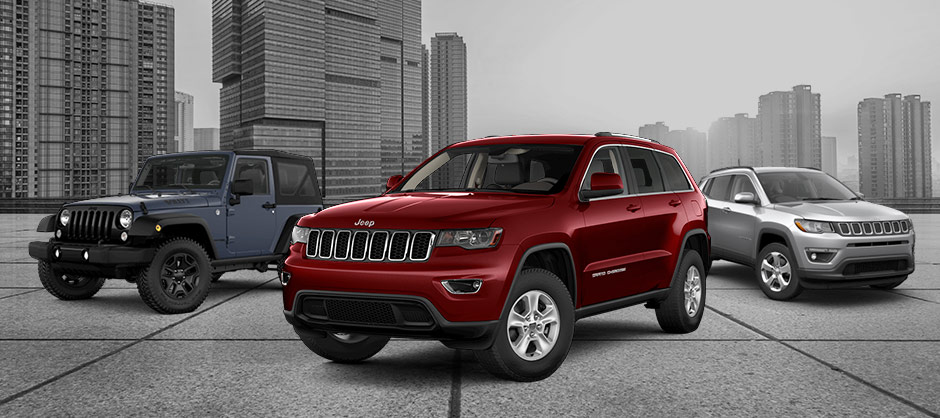 ineup of Grand Cherokee, Wrangler, Compass Pre-Owned Jeep line up with a city background